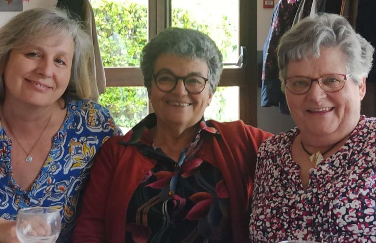 Trois convives souriantes lors d'un repas convivial